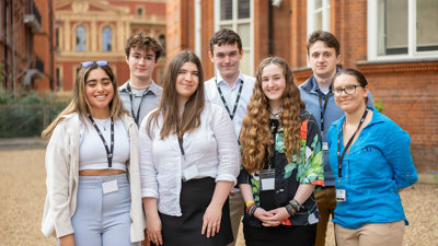 Young people stood at the Royal Geographical Society with the Royal Albert Hall in the background.