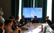 Explore attendees sit around table in Council Room during workshop on marine science and exploration.
