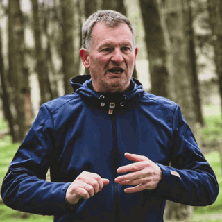 Martin Murphy in a forest wearing athletic wear.