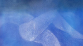 Abstract still of a shape of a body under water.
