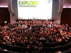 Delegates in the Ondaatje Theatre at the RGS Explore Weekend 2025, waving their hands in the air,
