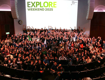 Delegates in the Ondaatje Theatre at the RGS Explore Weekend 2025, waving their hands in the air,