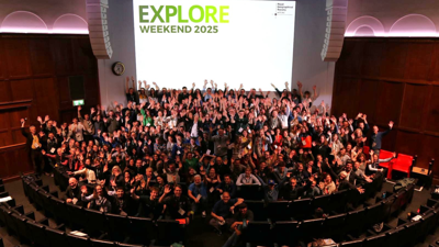 Delegates in the Ondaatje Theatre at the RGS Explore Weekend 2025, waving their hands in the air,