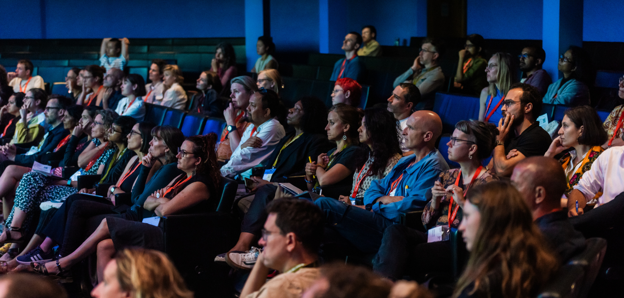 Delegates watching a lecture at the annual conference in 2024, in the Ondaatje Theatre
