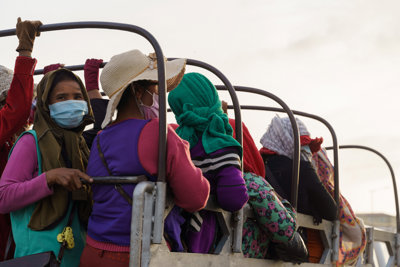 Women sitting in the back of a truck