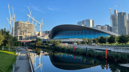 River flowing in urban area amongst modern buildings. 
