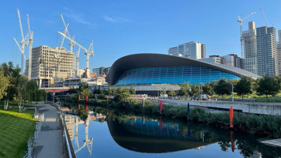 River flowing in urban area amongst modern buildings. 