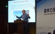 Murray Gray standing on stage giving a talk.