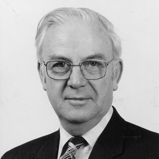 Stanley Gregory in suit and tie.