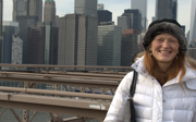 Susan Smith smiling at the camera with skyscrapers in the background.