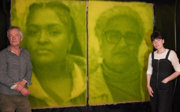 Ackroyd & Harvey standing next to two of their photographic photosynthesis portraits of Chenae Bullock and Elizabeth Solomon