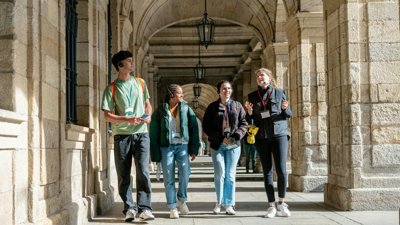 Four people taking tour of university campus.