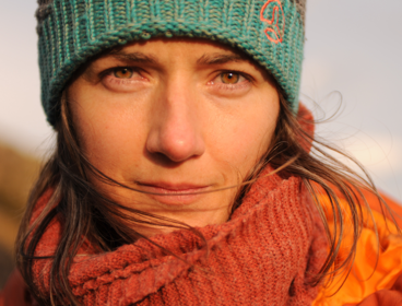 Headshot of person wearing red scarf.