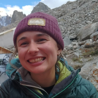 Headshot of Erin Linwood in rocky landscape.