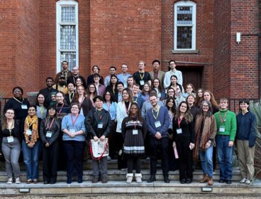 Group of Postgraduate students standing at the steps of the RGS terrace.