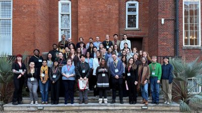 Group of Postgraduate students standing at the steps of the RGS terrace.