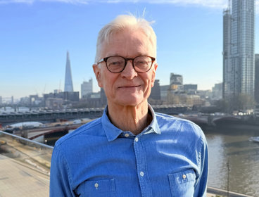 Nicholas Crane standing on a rooftop in London.