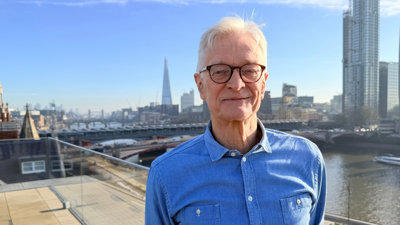 Nicholas Crane standing on a rooftop in London.
