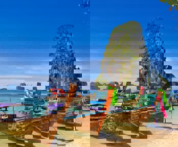 Colourful fishing boats on a tropical Thai beach