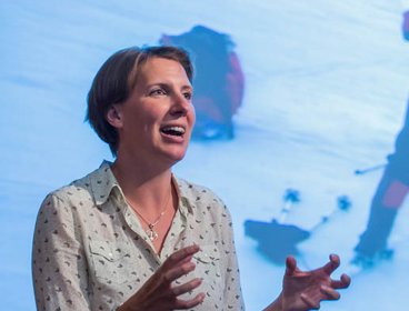 Felicity Aston on a stage giving a presentation.