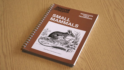 A copy of Expedition Field Techniques: Small Mammals on a desk.