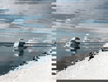 A view over Antarctica showing mountains and penguins