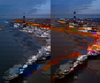 An aerial view over Blackpool beach at dusk