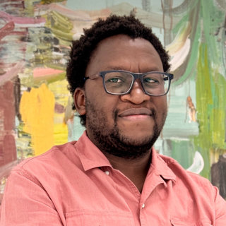 Busisani Dube in a pink shirt against a colourful background.