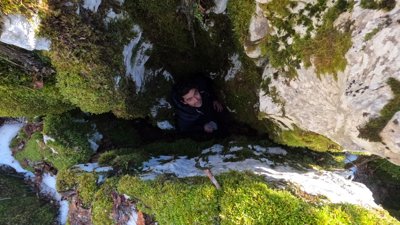Person standing in between rock formation. 