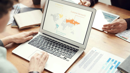 Person on a laptop showing a map of the world.