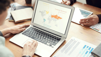 Person on a laptop showing a map of the world. 