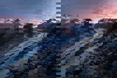 A glacier moving down a mountain valley