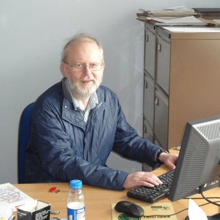 Robin Flowerdew working at a desk behind a monitor.