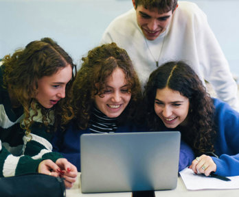 People looking at a laptop and smiling.