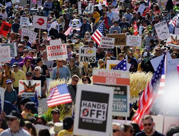Protest in America with crowd of people holding signs and flags.