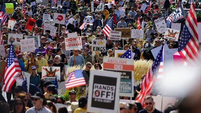 Protest in America with crowd of people holding signs and flags.