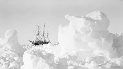 Old black and white photograph of the Endurance ship stuck in ice.