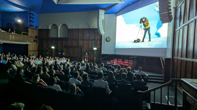 Audience watching films in the Ondaatje Theatre at the summer film night.