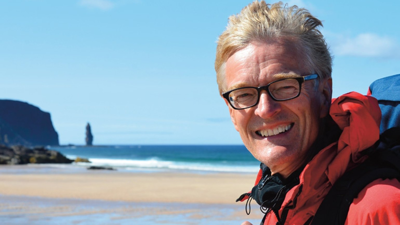 Nicholas Crane with a beach in the background