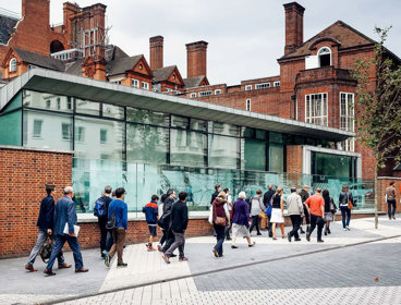 People walking along Exhibition Road outside of the Society's entrance.