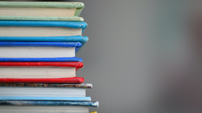 A stack of books sit on left hand side. 