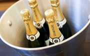 A close up shot of champagne bottles in an ice bucket. 