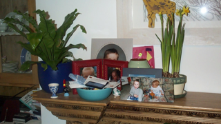 Collection of items with sentimental value such as baby photos on a mantelpiece.
