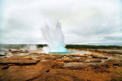 Geyser eruption with steam