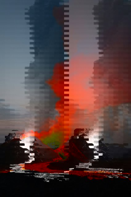Silhouette of volcano under cloudy sky during daytime