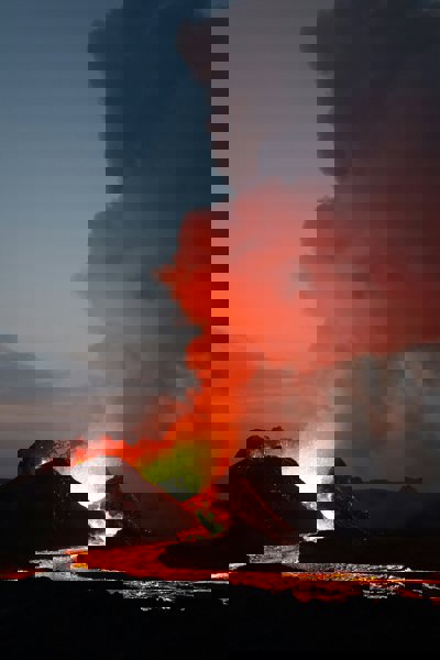 Silhouette of volcano under cloudy sky during daytime
