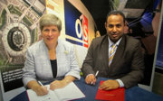 Two people signing an official document.