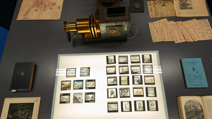 Display of historic materials, including photographs, lantern slides, and books.