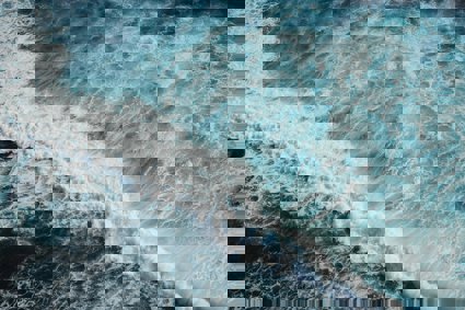 Foaming waves in the ocean viewed from above