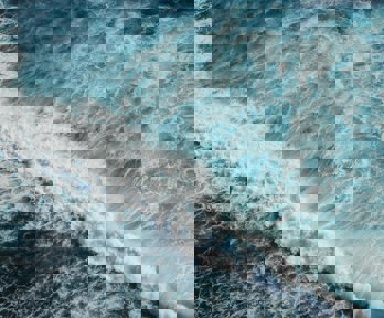 Foaming waves in the ocean viewed from above